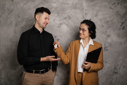 Real estate agent handing over keys to a home buyer
